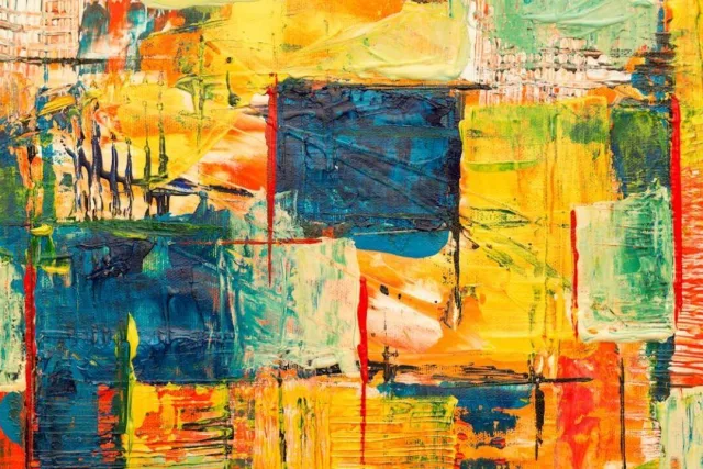 A close-up of an abstract oil painting in blue, yellow and red